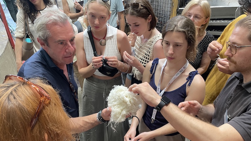 Fabrizio Tesi from Comistra shows the Summer Scholl students recycled wool fibres. Photo: ADDTEX, Katja Brencic