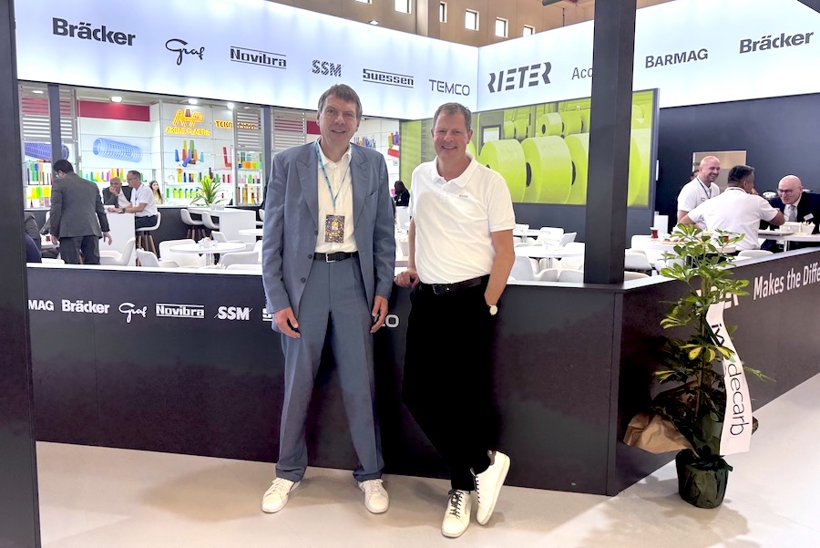 Thomas Oetterli (right) and TexData Editor-in-Chief Oliver Schmidt in front of the Rieter booth at ITM 2026 © 2026 TexData International