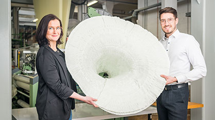 Dr.-Ing. Cornelia Sennewald and Dipl.-Ing. Dominik Nuss show their spherical curved preform, developed and produced at the ITM at TU Dresden © ITM TUD Dr.-Ing. Cornelia Sennewald and Dipl.-Ing. Dominik Nuss show their spherical curved preform, developed and produced at the ITM at TU Dresden © ITM TUD